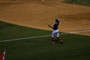 Back-up Catcher warming up the Outfield between Innings